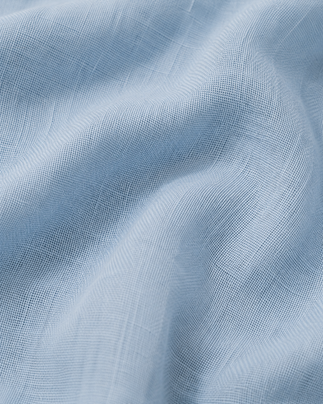 Close-up of the sky blue cotton fabric texture and soft folds.
