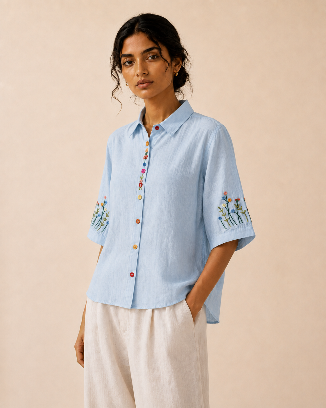 Alternate front view of the sky blue wildflower embroidered cotton shirt showing the relaxed fit and embroidery.
