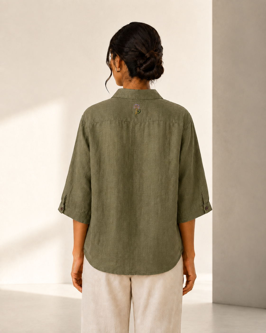 Back view of the olive green back embroidered embroidered linen shirt, showing the rear yoke and relaxed fit.
