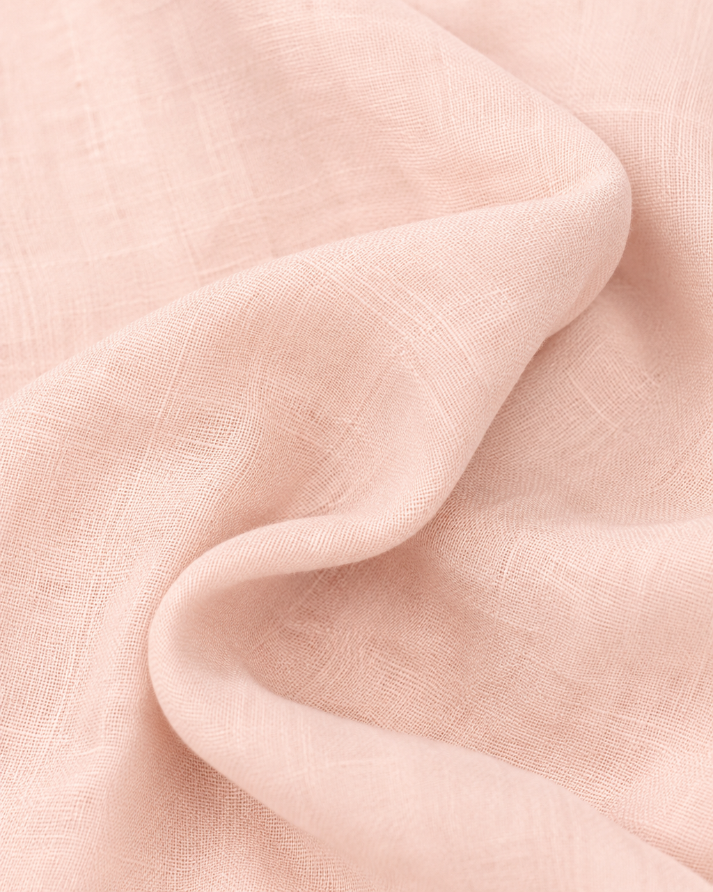 Close-up of the soft blush pink cotton fabric texture and soft folds.

