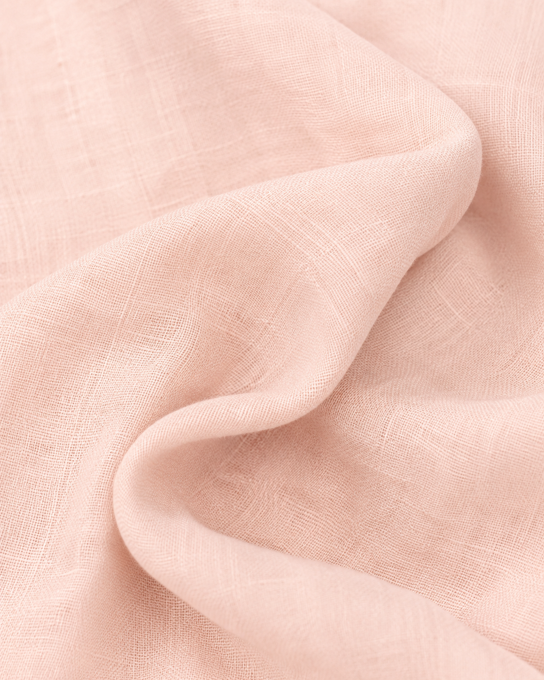 Close-up of the soft blush pink cotton fabric texture and soft folds.
