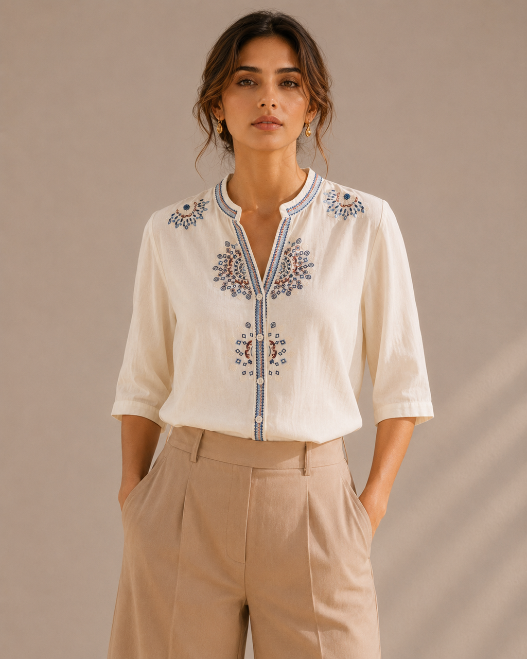 Woman wearing the warm ivory white medallion embroidered cotton shirt, front view.
