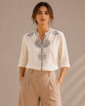 Woman wearing the warm ivory white medallion embroidered cotton shirt, front view.
