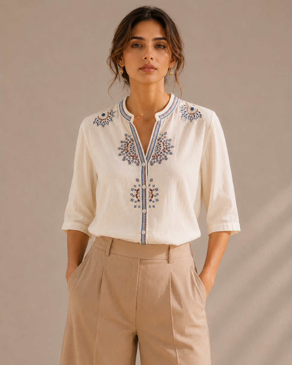 Woman wearing the warm ivory white medallion embroidered cotton shirt, front view.
